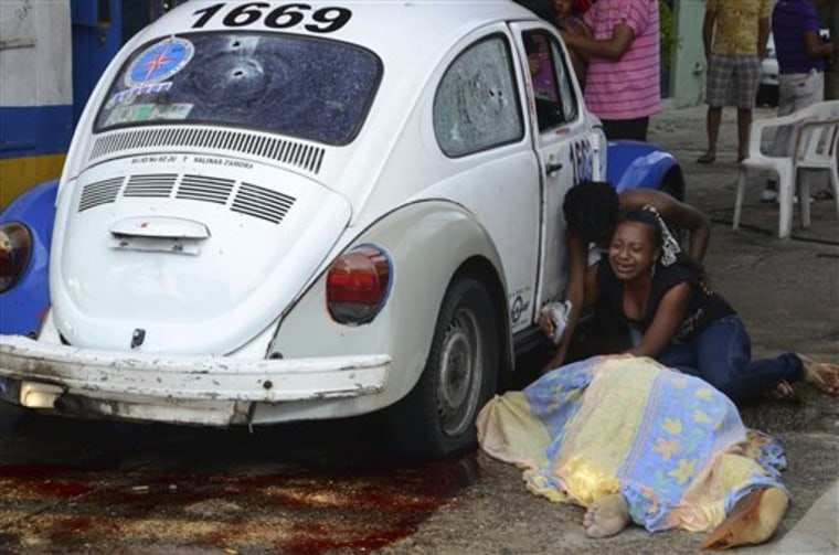 Relatives weep after gunmen opened fire on a taxi killing the driver and the passenger in the Pacific resort city of Acapulco, Mexico. The brutal public killings that began about five years ago have worsened as Mexican drug cartels try to one-up each other in their quest to scare off rivals.